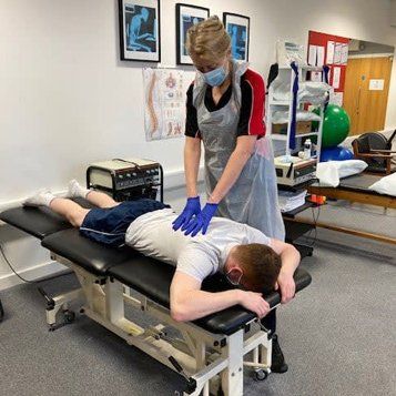 physiotherapist working on man's back