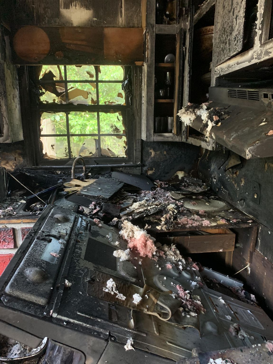 A kitchen that has been damaged by a fire