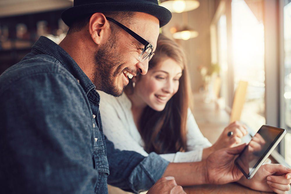 man and woman looking at device