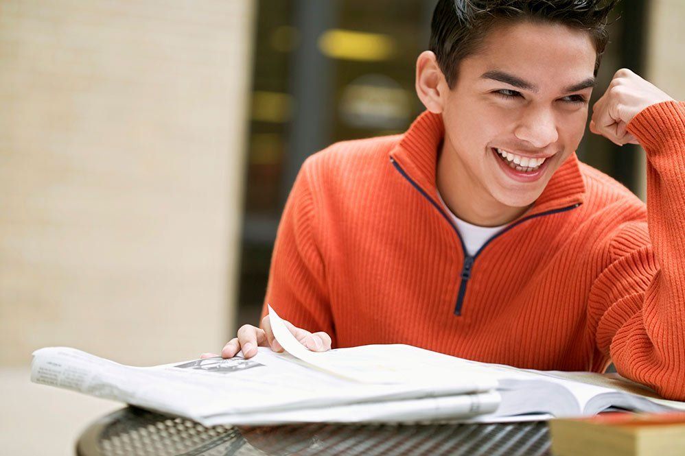 teen with orange jacket