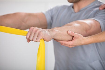 Physical Therapy — Man A Training With Exercise Band in Warren, OH Physical Therapy — Man A Training With Exercise Band in Warren, OH