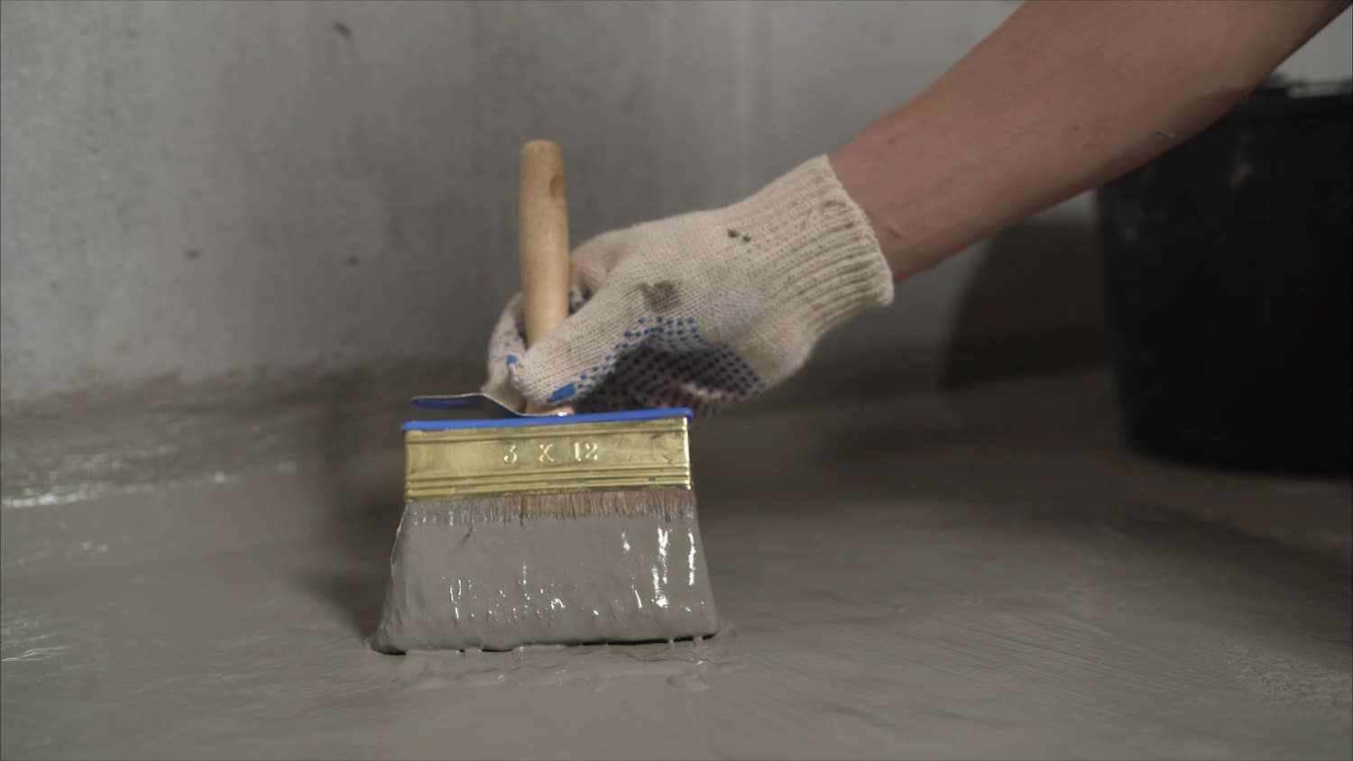 Brushing Waterproof Coating on the Floor — Watertight Services Australia in Taree, NSW