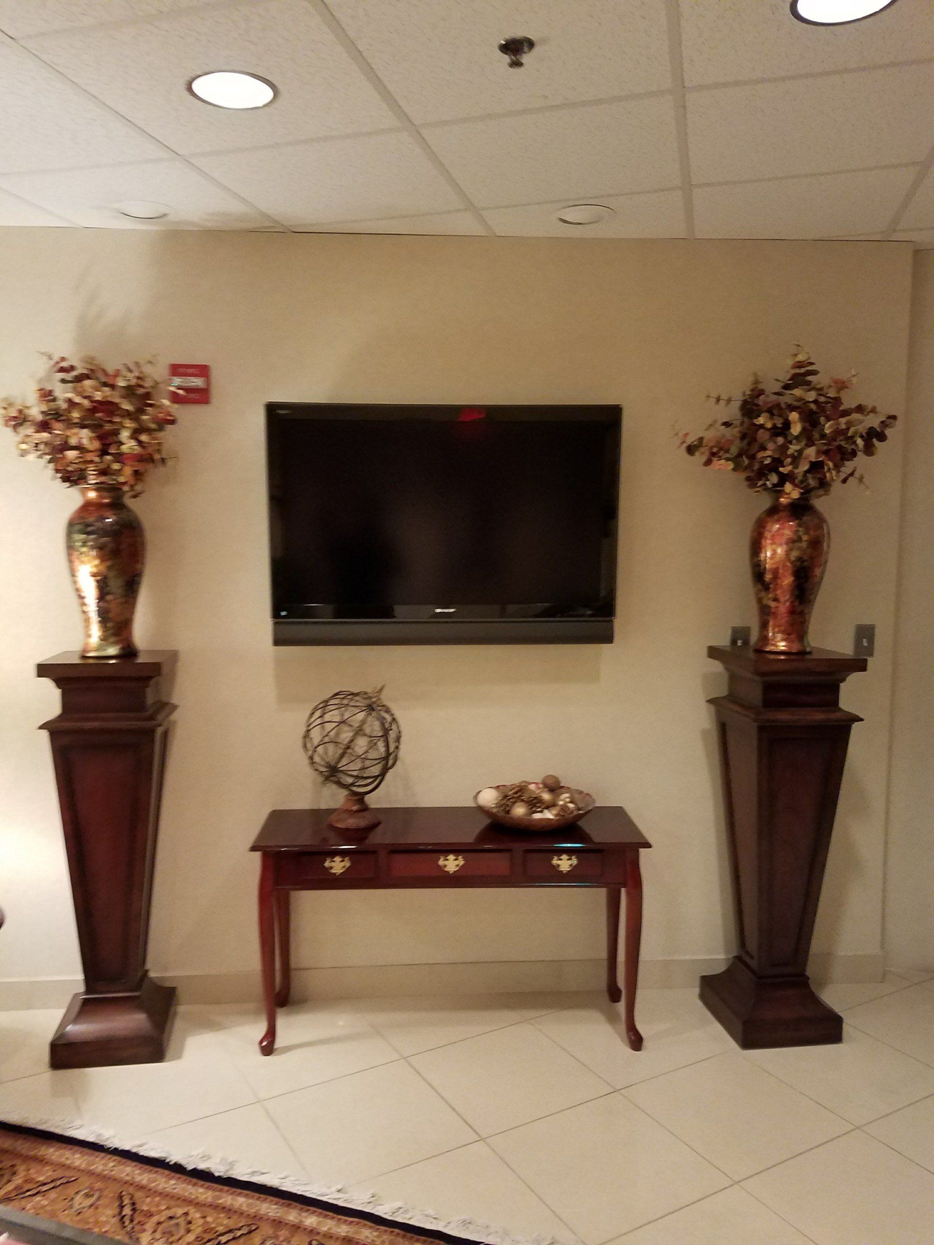 wall tv hanging with wall desk and vase decor by dismantle furniture