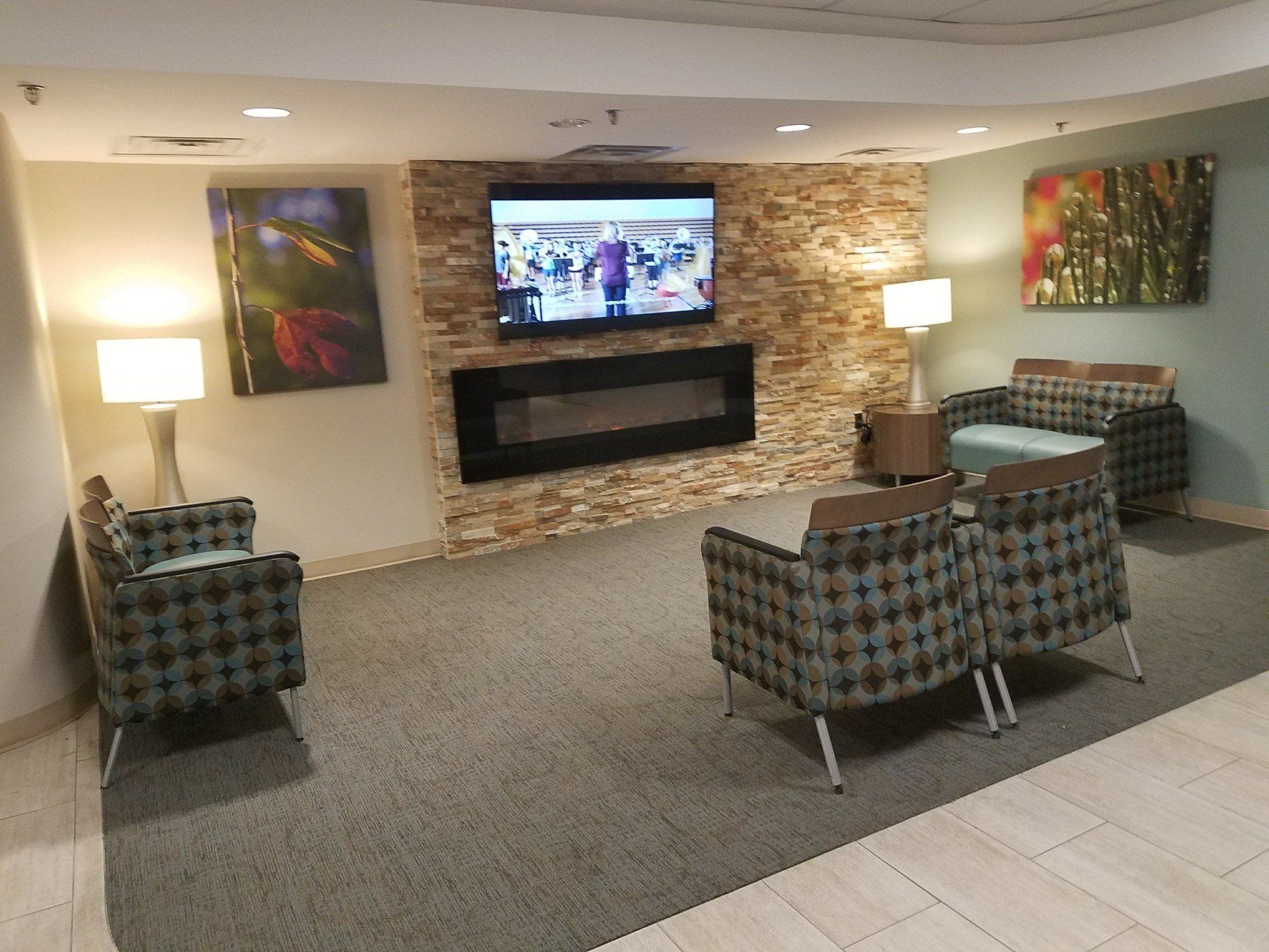 A living room with a fireplace and a flat screen tv