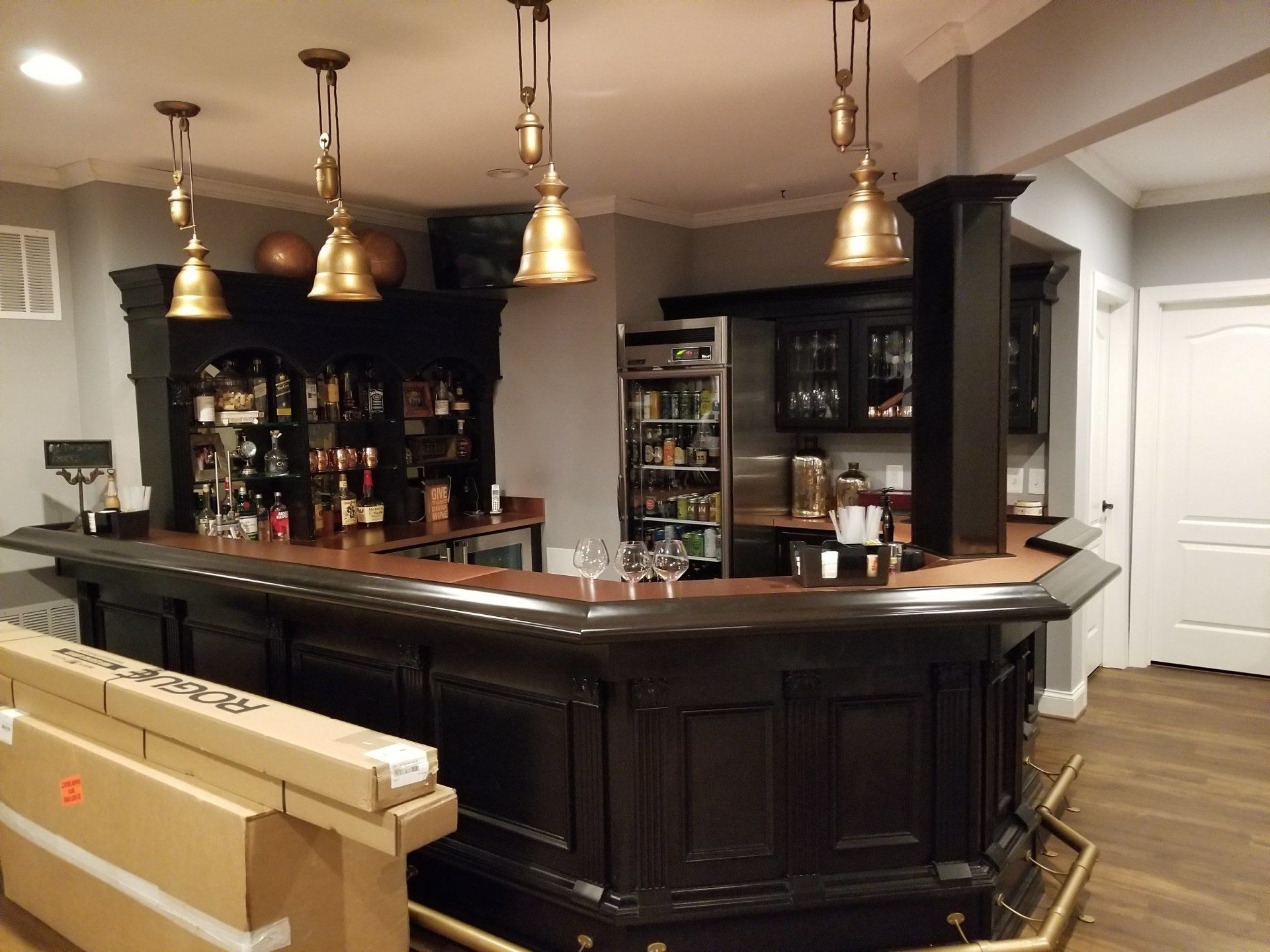 english style pub table with overhead lamps and alcohol cabinets by furniture assembly team