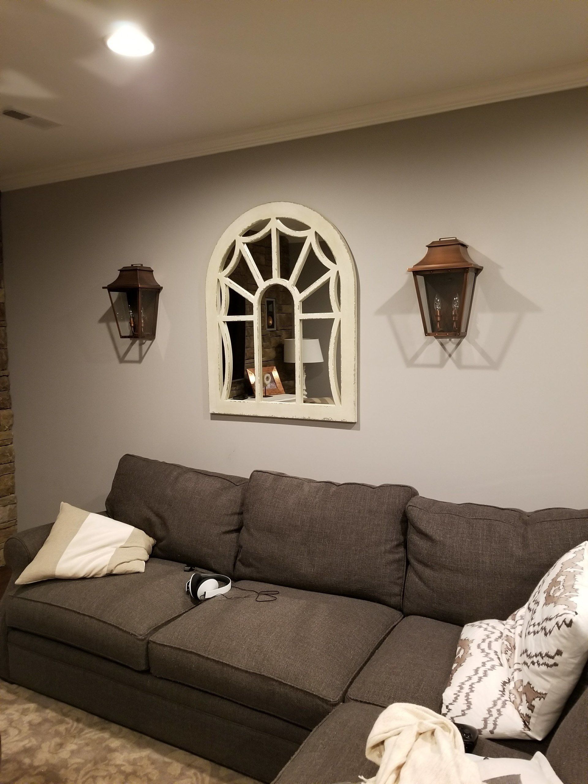 man cave basement with sofa, window, and lantern style lights by furniture assembly team