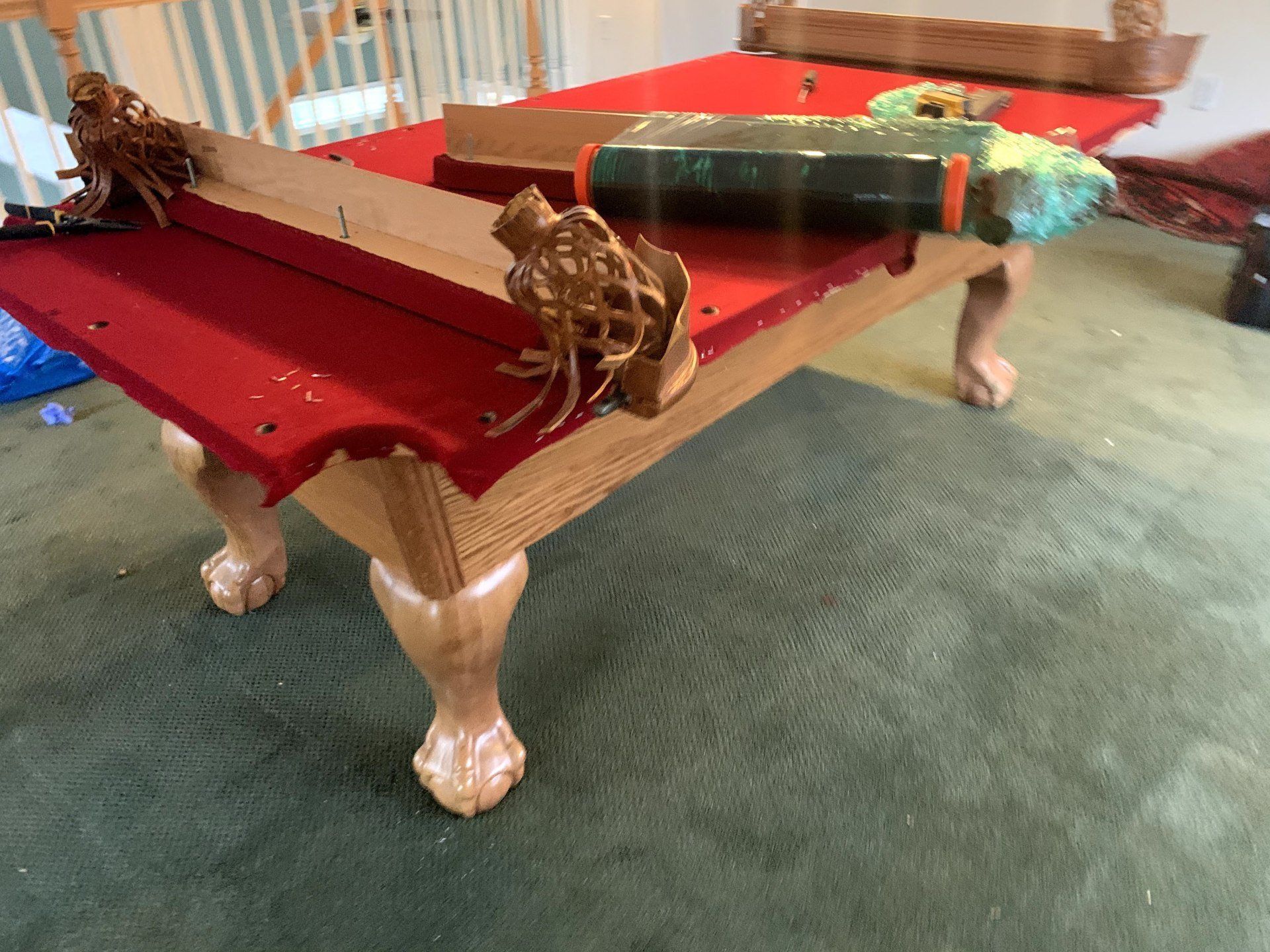 completed red velvet slate pool table with pool cues by furniture assembly team