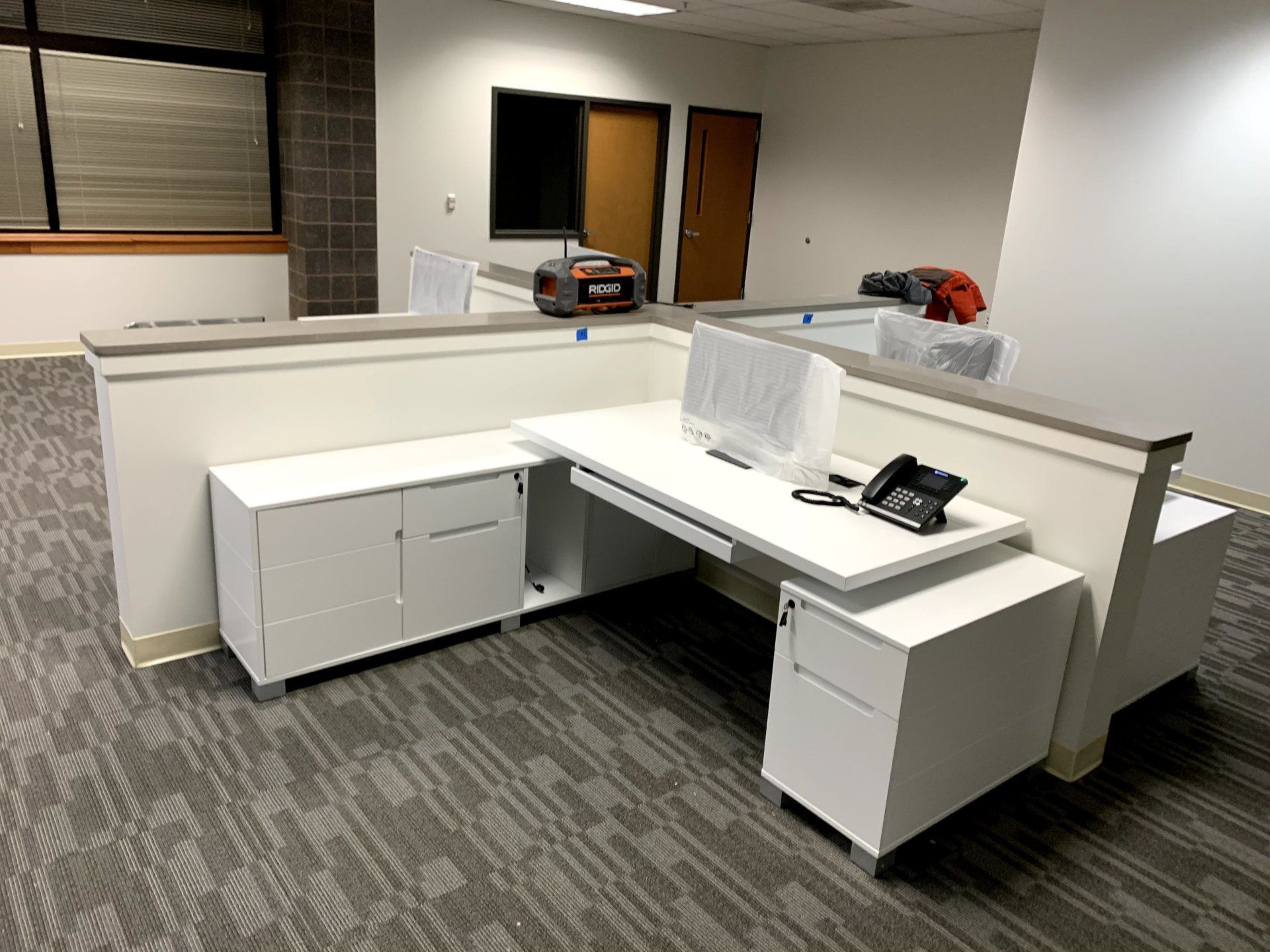 white Ford Zuri desk with left turn by furniture assembly team