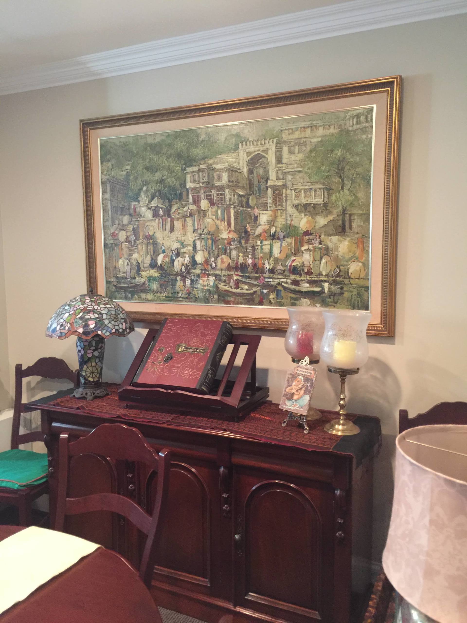 large landscape painting with an ancient wooden bookrest and mosaic lamp by dismantle furniture