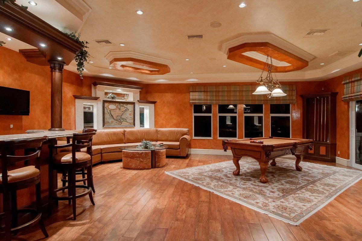 Living room design with brown wood pool table , sofa and coffee table