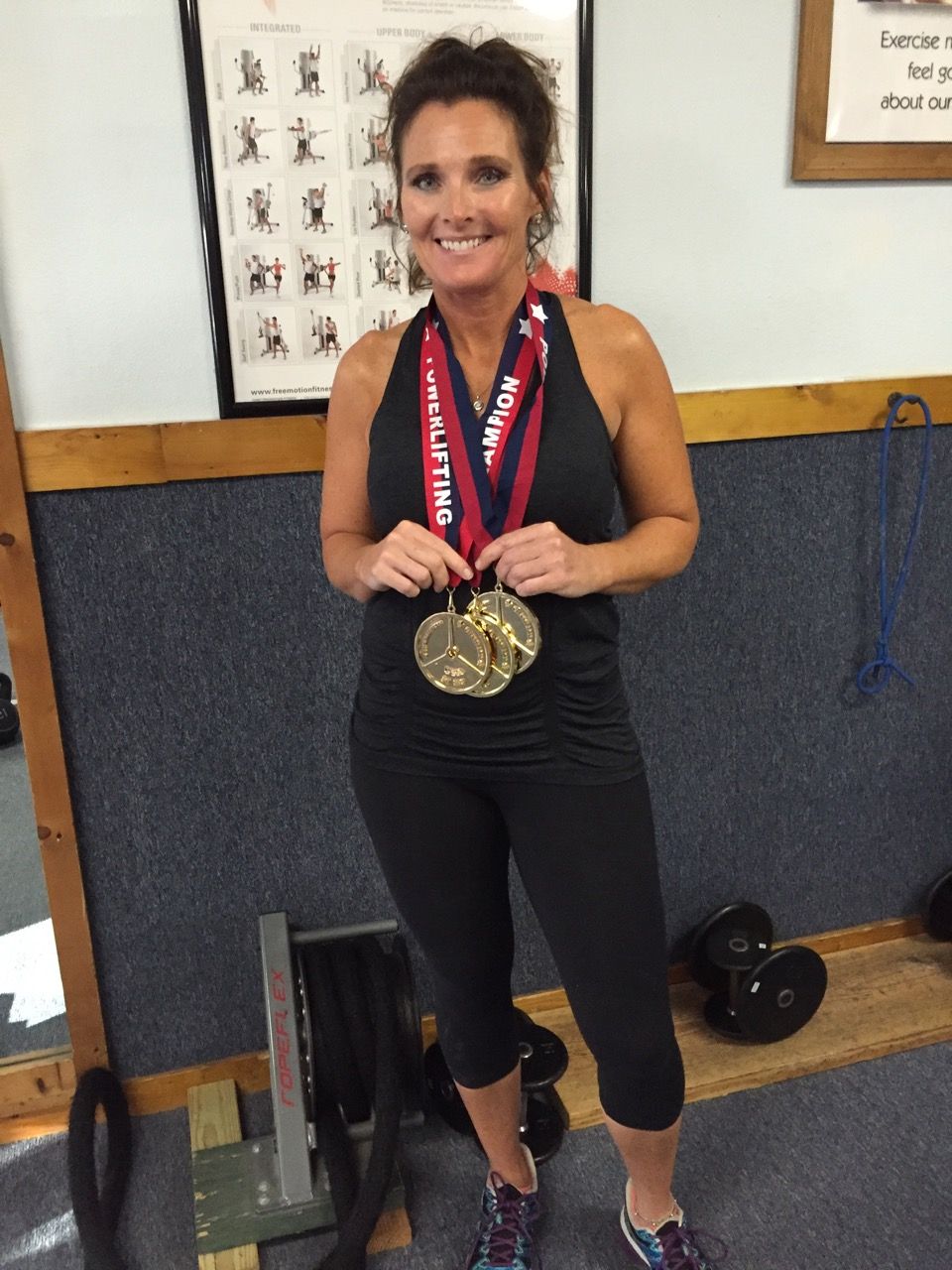 A woman wearing a medal around her neck that says cali time