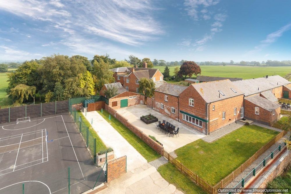 A aerial photo of tennis court and cottages