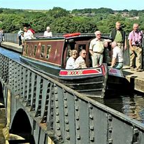 Pontcysyllte Aqueduct in Wales Canal boat with people crossing Pontcysyllte Aqueduct