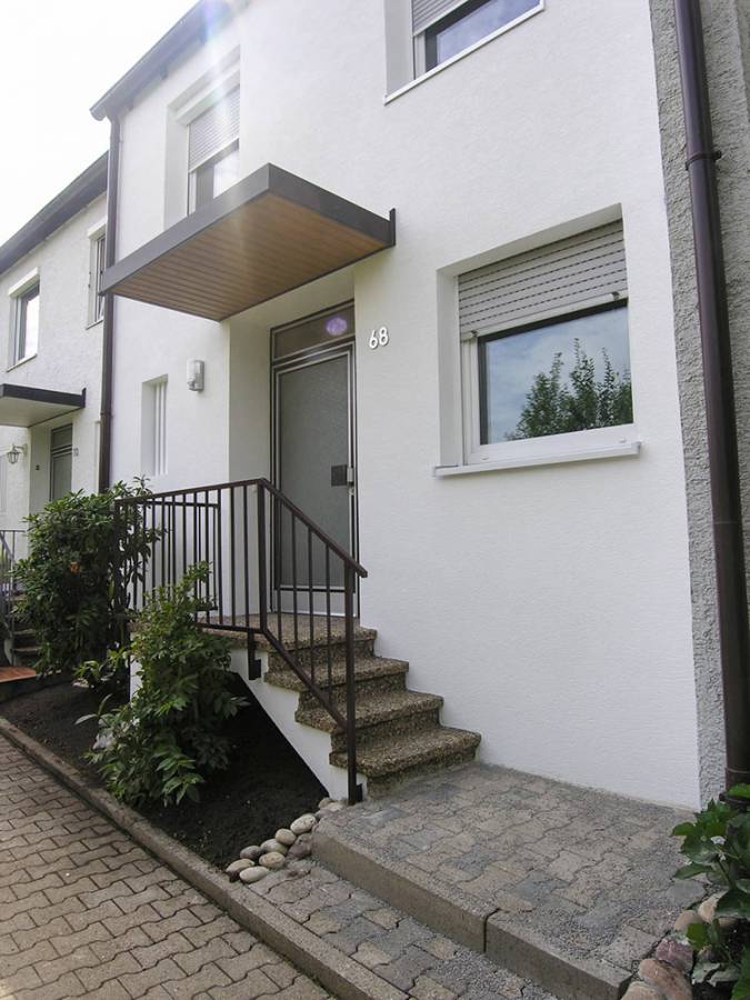 A white house with stairs leading up to the front door