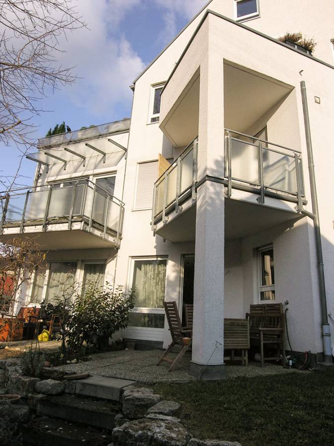 A large white house with balconies and stairs