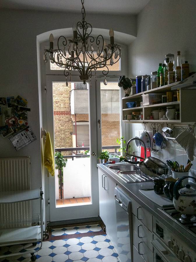 A kitchen with a chandelier hanging from the ceiling