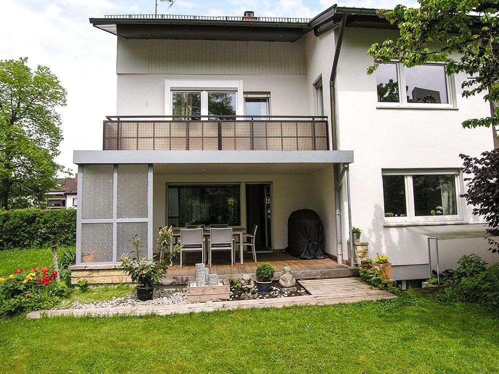 A white house with a balcony and a patio