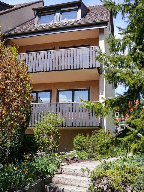 A house with a balcony and stairs leading up to it