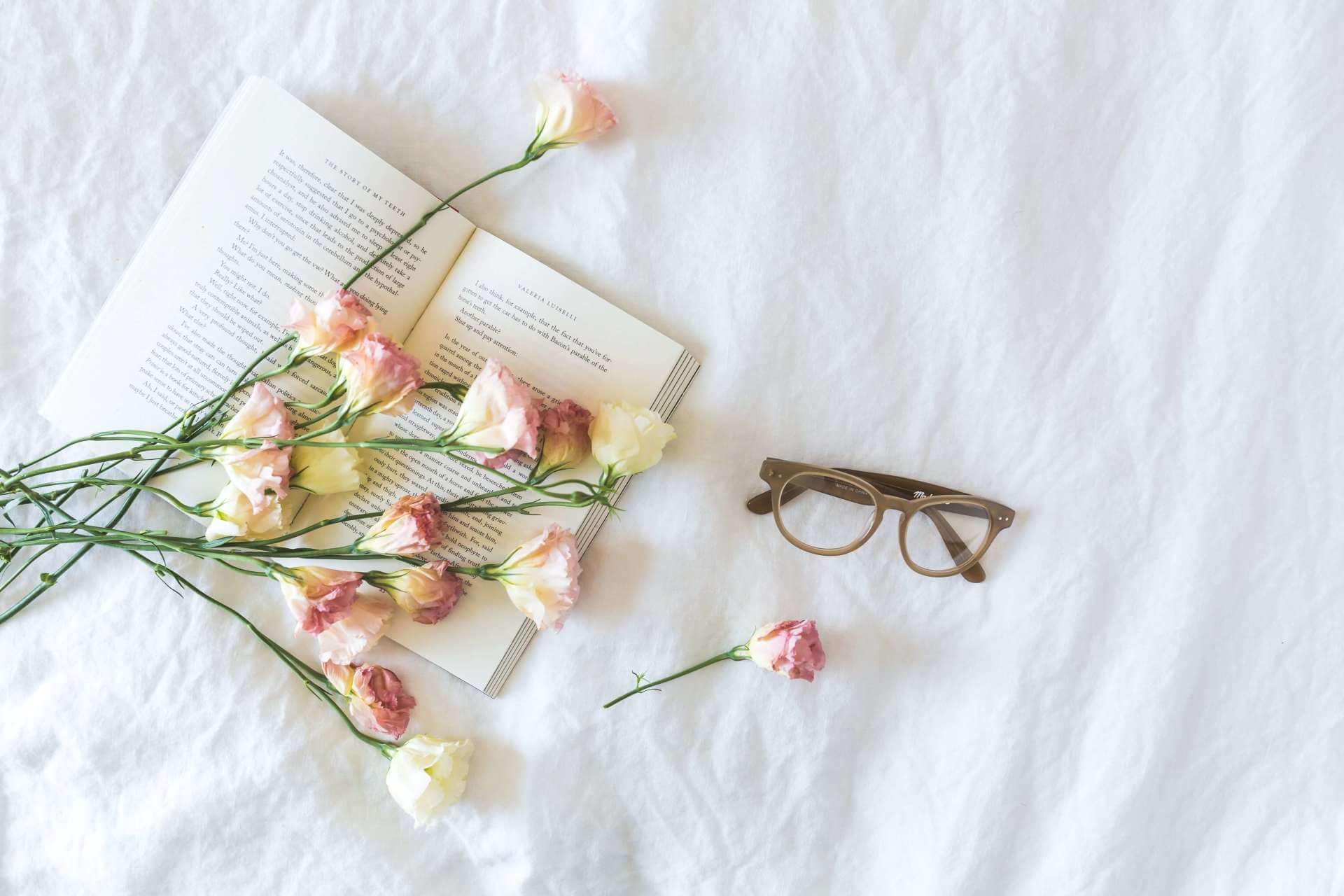 book about funeral aftercare with glasses and flowers