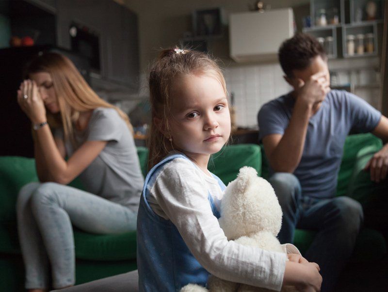 Determining Custody for a Child — Omaha, NE — April Cover Attorney At Law Child with stuffed bear, parents on couch with sad expressions.