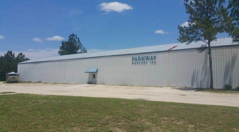 White warehouse building with blue lettering 