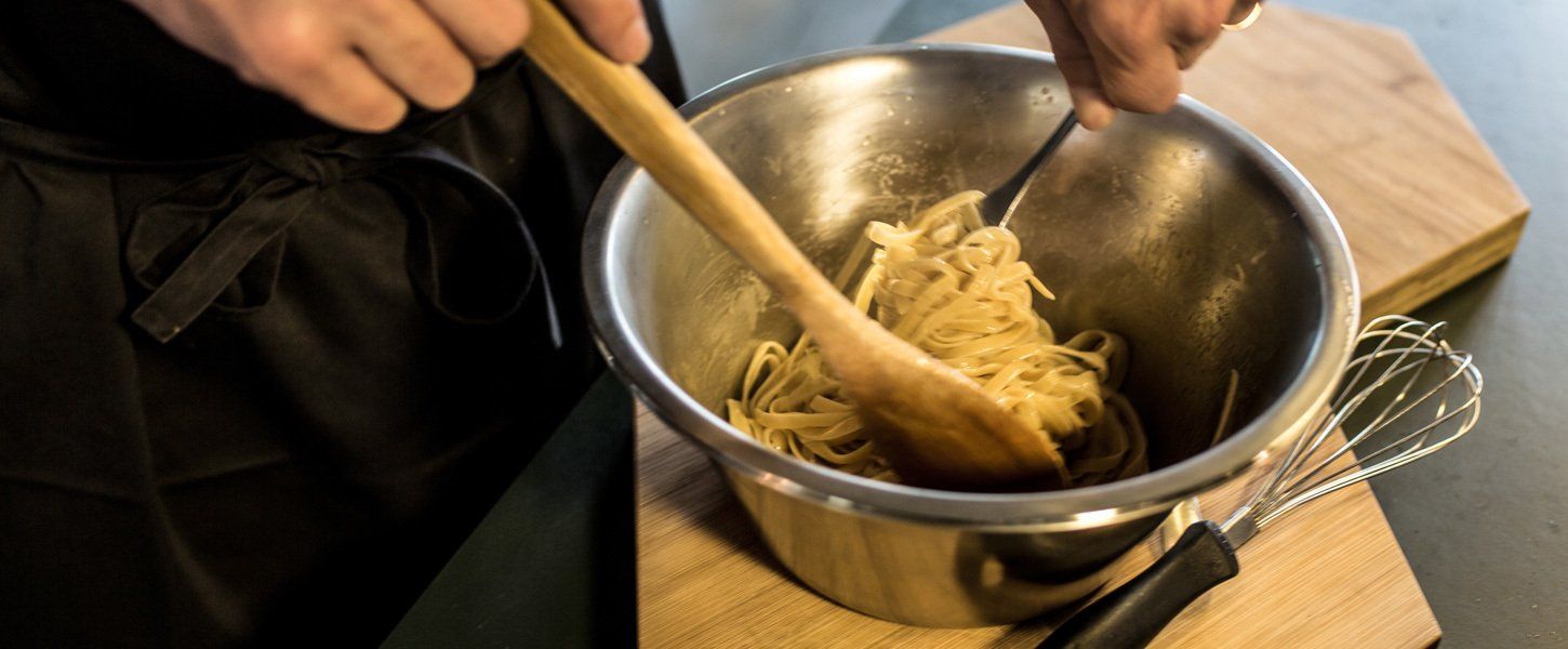 Chef tossing pasta