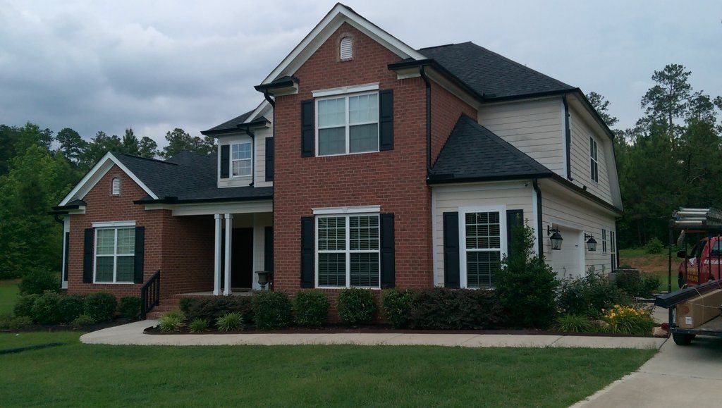 Appling home with black gutters view 2