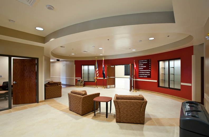 A large room with chairs and a table in it