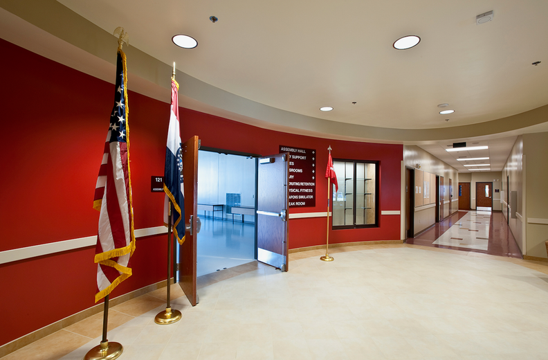 A hallway with red walls and american flags