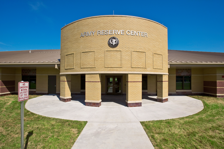 A large brick building with a circular walkway leading to it.