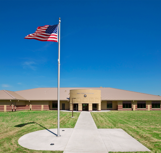 An american flag is flying in front of a building