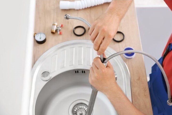 New white porcelain Bathroom sink being installed by a handyman service provider