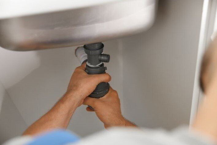 Plumber installing a bathroom faucet