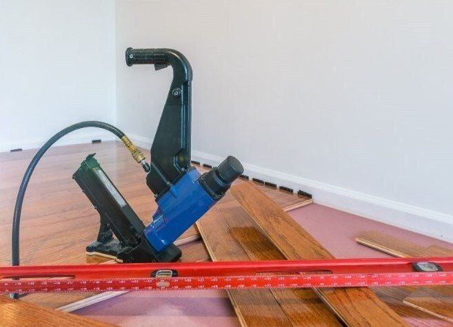 Installing new flooring with laminate cutter