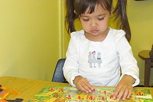 A little girl doing hands-on work at preschool
