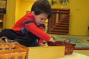 A little boy working on an activity at preschool