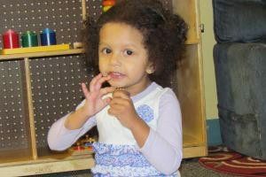 A girl in preschool smiling