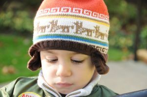 A preschool student with a knit hat on