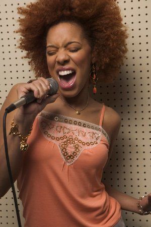 woman singing in a booth