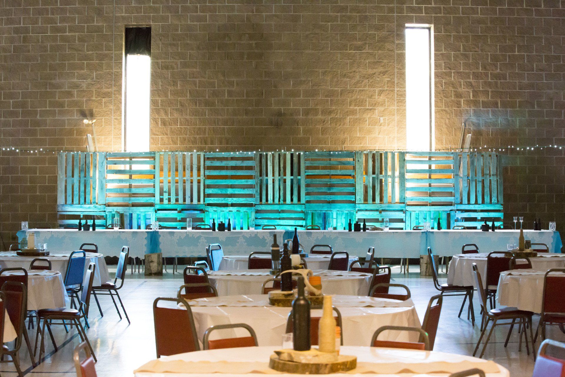 A large room with tables and chairs set up for a party
