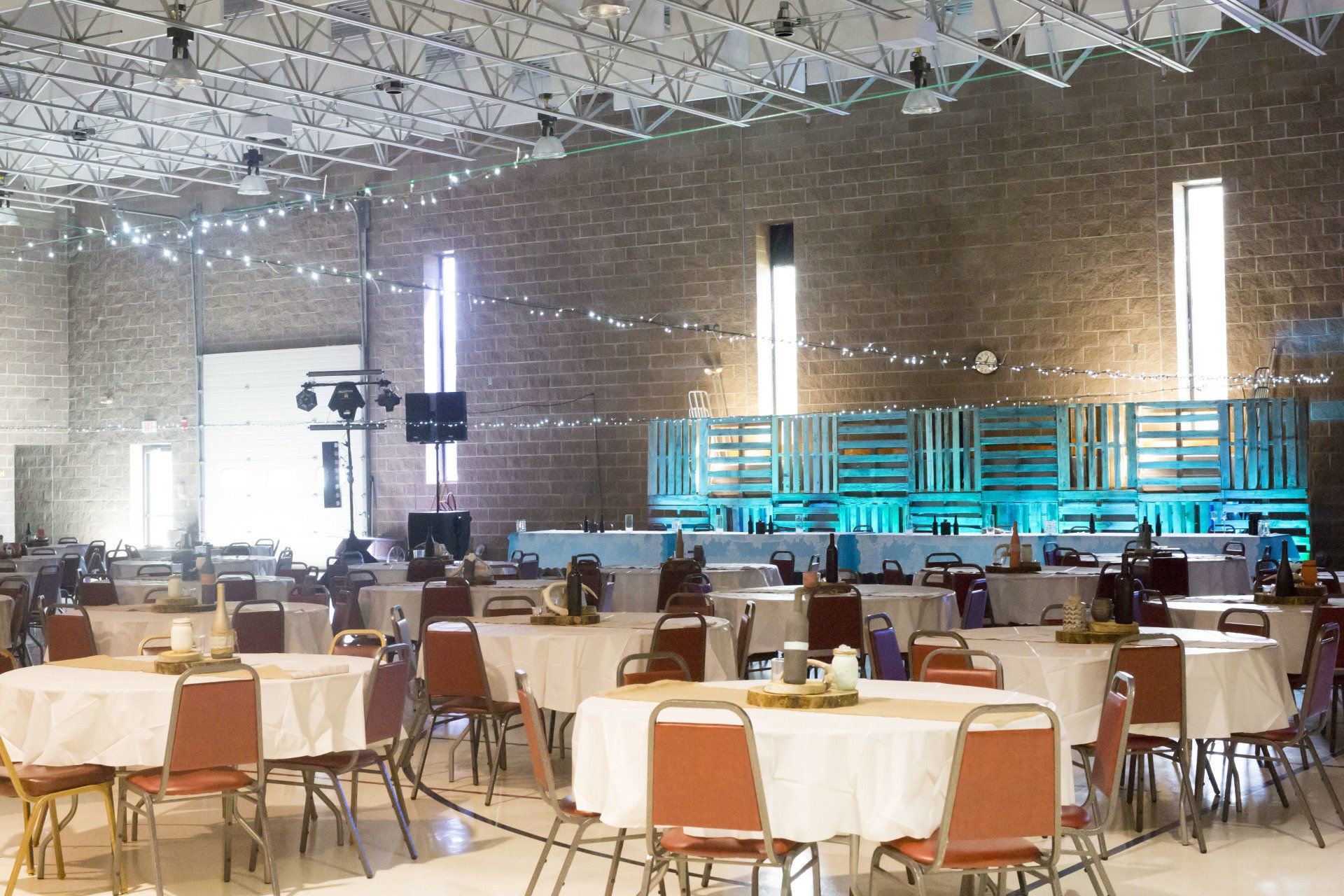 A large room with tables and chairs set up for a party