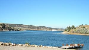 A large body of water with a dock in the middle of it.