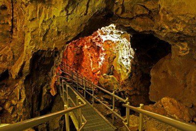 There is a staircase leading to the entrance of a cave.