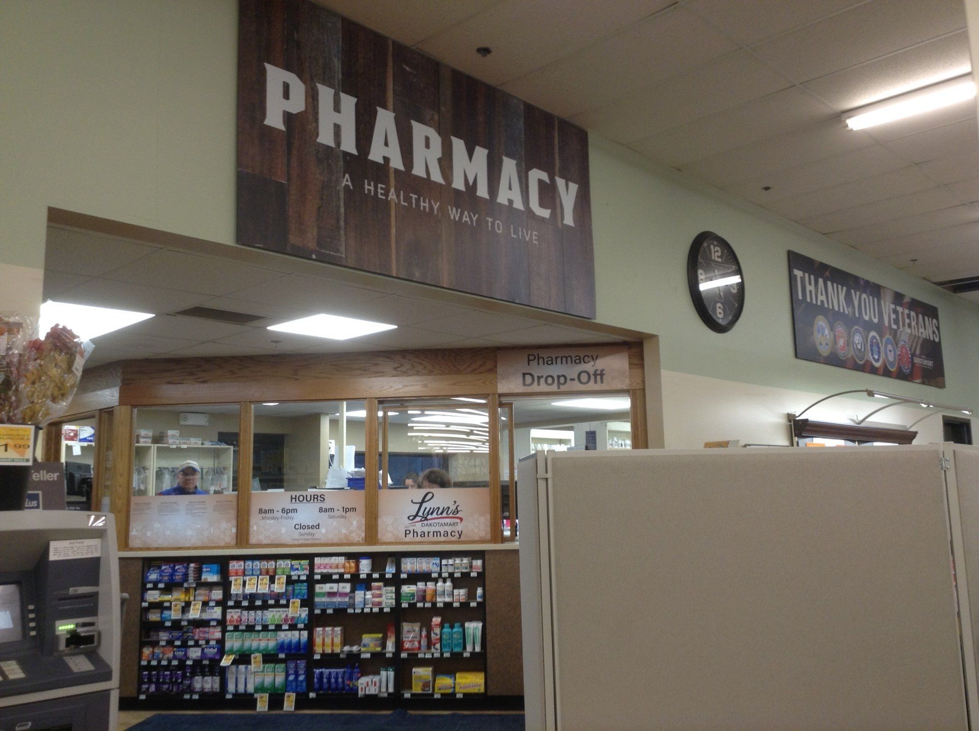 A pharmacy with a wooden sign above it