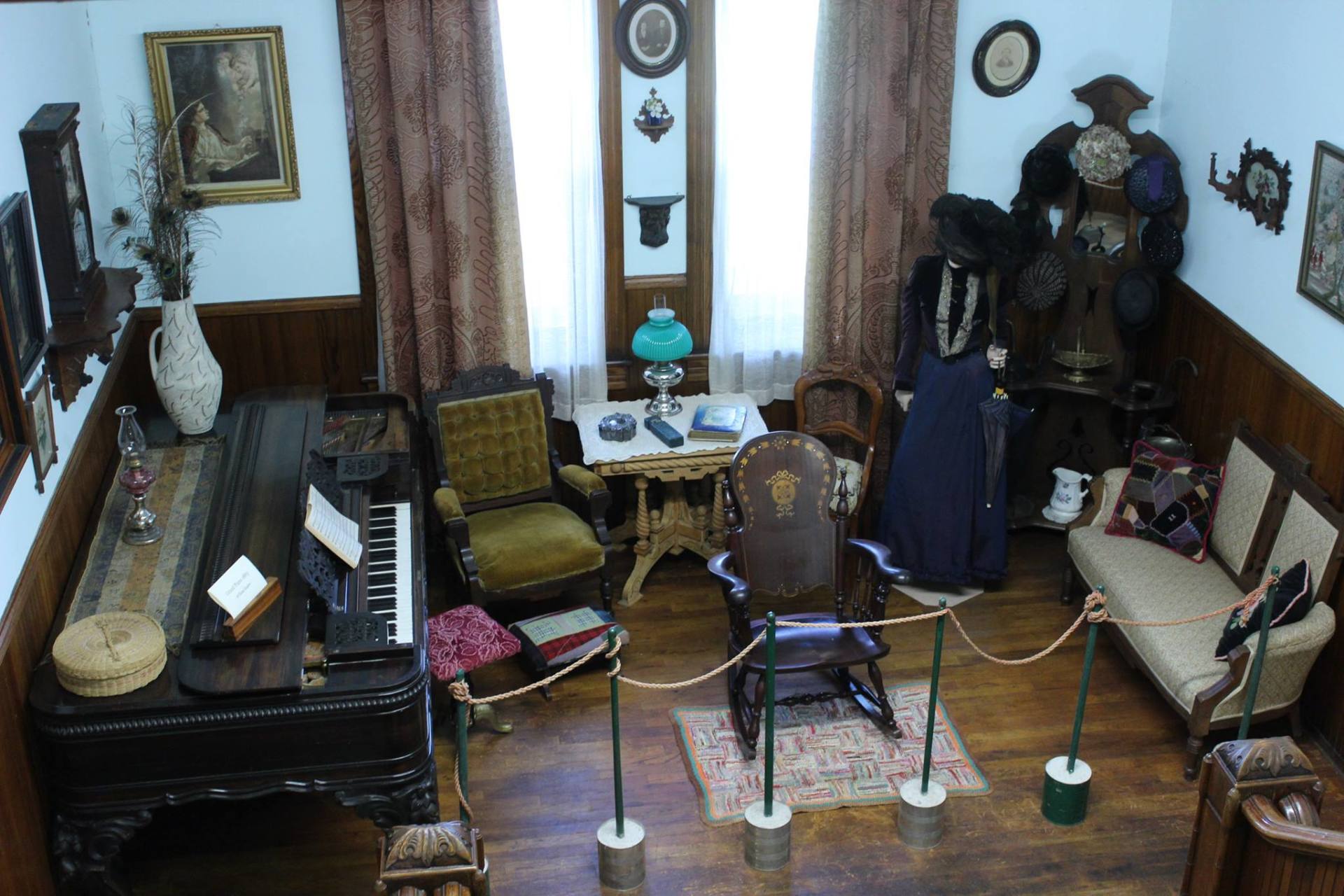 A living room with a piano , chairs and a couch