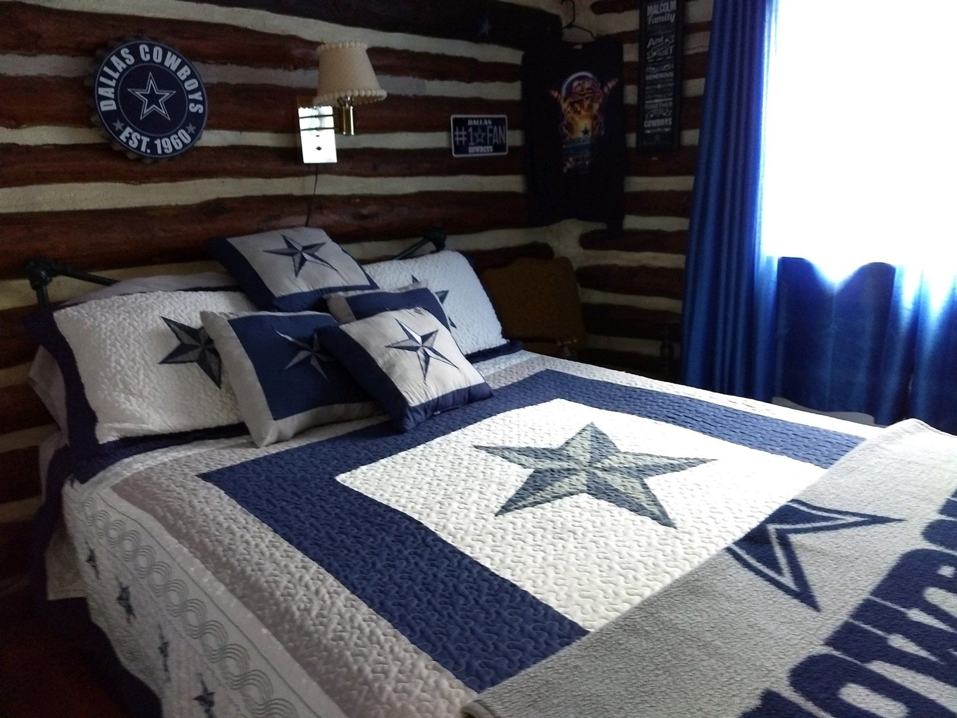 A bed with a blue and white quilt with a star on it