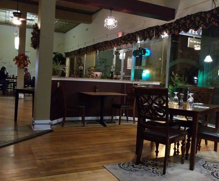 The inside of a restaurant with tables and chairs