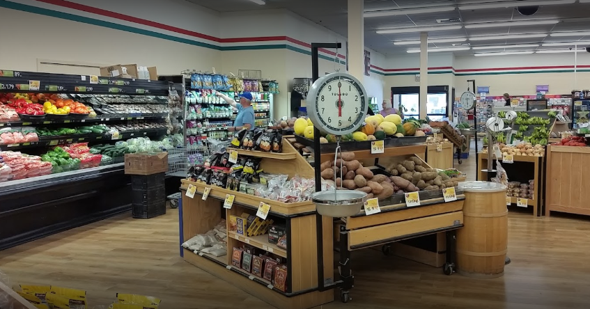 A grocery store filled with fruits and vegetables and a scale.