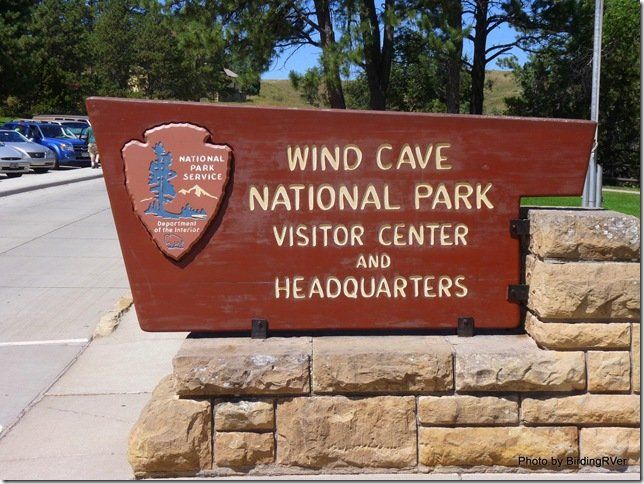 A sign for wind cave national park visitor center and headquarters