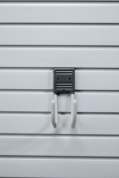 A hook is hanging on a white wall.